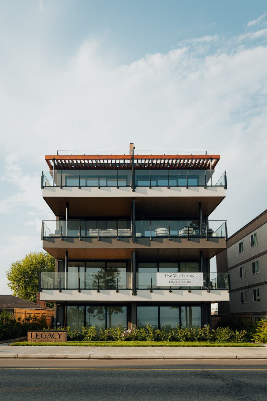 Looking up at the rooftop terrace canopy and top-floor balconies