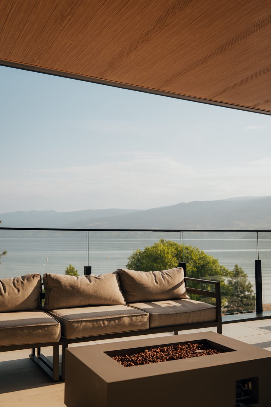 Outdoor lounge seating around a fire table on the rooftop terrace